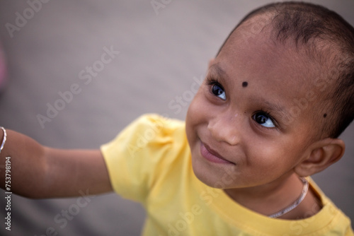 Portrait of a little girl smiling and looking upwards photo