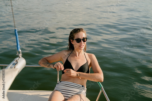 Young Woman Enjoying Summer Time on a Sailboat