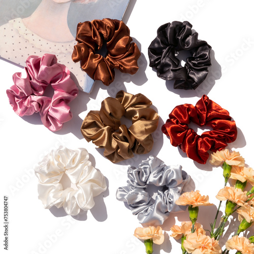 Set of silk satin scrunchies on white background photo