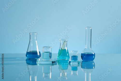 Laboratory glassware with liquid isolated on blue photo