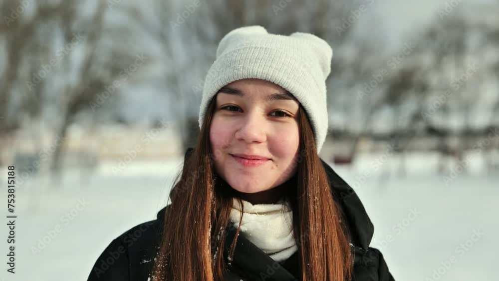 Portrait of a schoolgirl before a snowball arrives in her face. Portrait of a schoolgirl before a snowball arrives in her face.