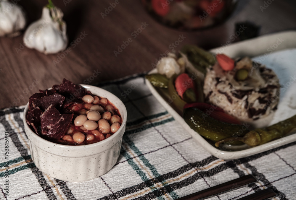 traditional turkish white beans stew with bacon, boiled rice and salted marinade vegetables, cucumbers, green tomatoes, carrot, pepper, served ready to eat kuru fasulye traditional turkish white beans stew with bacon, boiled rice and salted marinade vegetables, cucumbers, green tomatoes, carrot, pepper, served ready to eat kuru fasulye