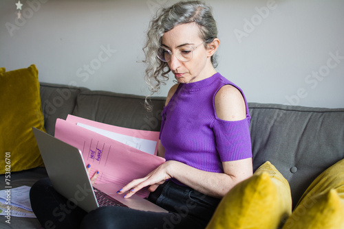 Stressed woman working on her mortgage paperwork photo