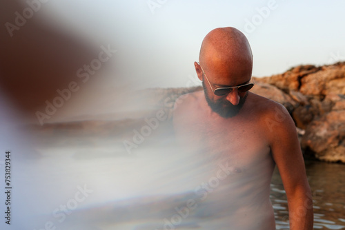 Person at beach searching looking down for something on the ground  photo