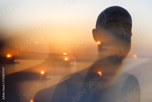 Portrait of a man in front of the sunset with a kaleidoscope effect  photo