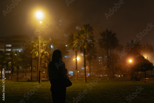 Woman in a dark park