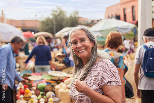 Portrait of an older traveler smiling at the camera in Marrakesh. photo