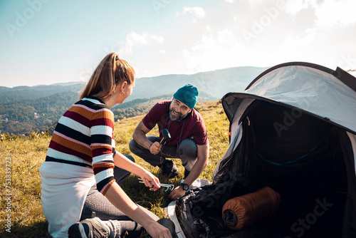 Young couple camping with tent in the mountains photo