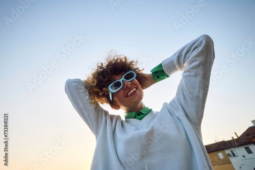 Happy woman tightens her hair photo