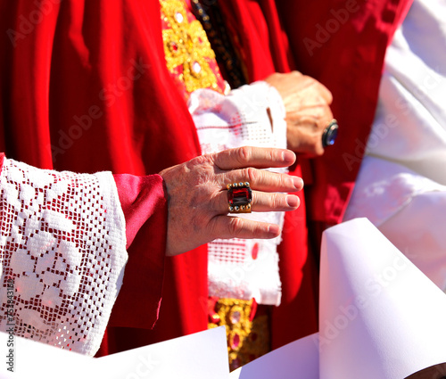 Bild auf Leinwand Bishop in red religious attire blesses the faithful with hand