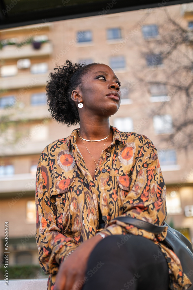black woman sitting at city bus stop black woman sitting at city bus stop