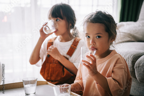 Cute young children drinking water  photo