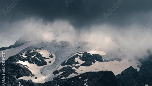 Close-up timelapse of summer storm clouds forming around Piz Ferrè Glacier