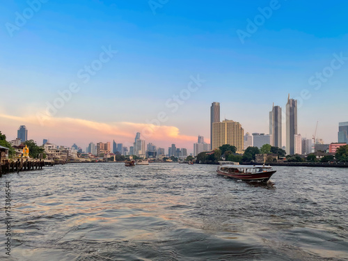 View of Bangkok's central business district from the Chao Phraya River at sunset. The river meanders south through the city and empties into the Gulf of Thailand
