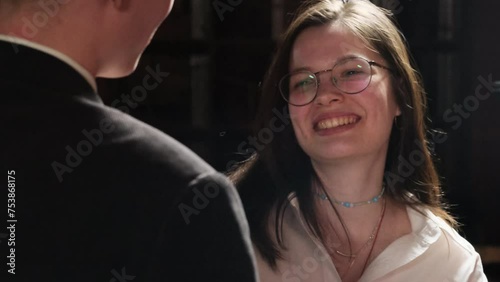 Young lady with magnificent smile enjoys conversation in pub. Romantic couple talks on date spending leisure time together