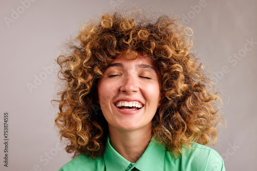 Laughing curly woman in the studio photo