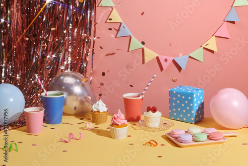 Fresh tasty cupcakes and birthday decor on glitter background photo