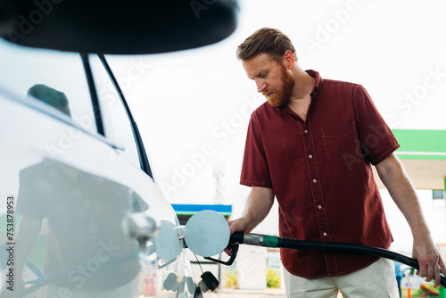 Man Refilling Car Tank with Petrol  photo