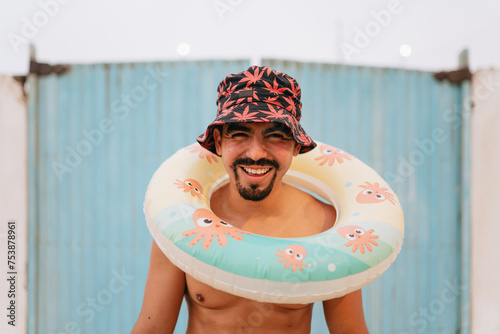 Happy shirtless man with float photo