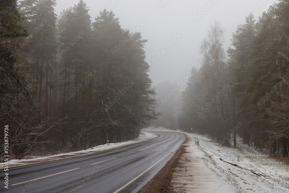 beautiful snow-covered road during fog in winter beautiful snow-covered road during fog in winter