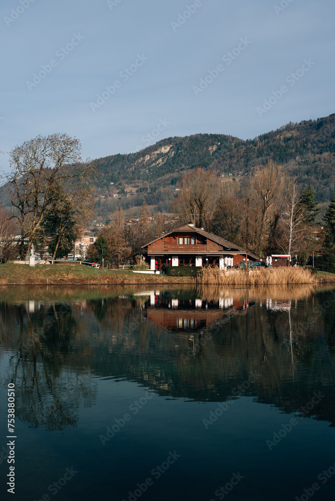 wooden house by the lake near the mountains in France