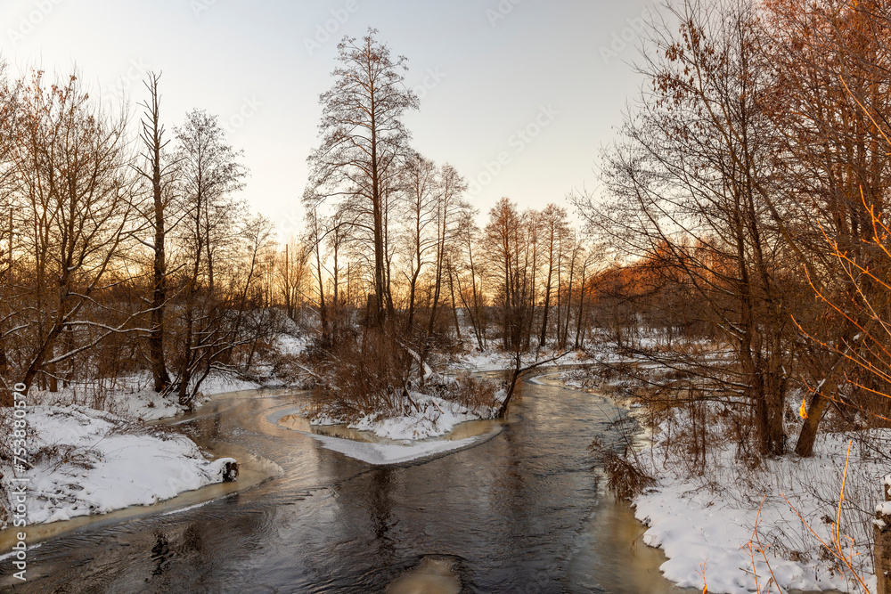 sunset on a river whose banks are covered with ice sunset on a river whose banks are covered with ice
