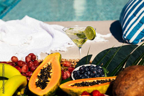 Fresh fruit platter and drink by the pool photo