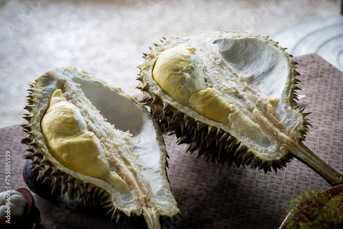 A ripe durian fruit cut in half to eat on table in Pattani, Thailand photo