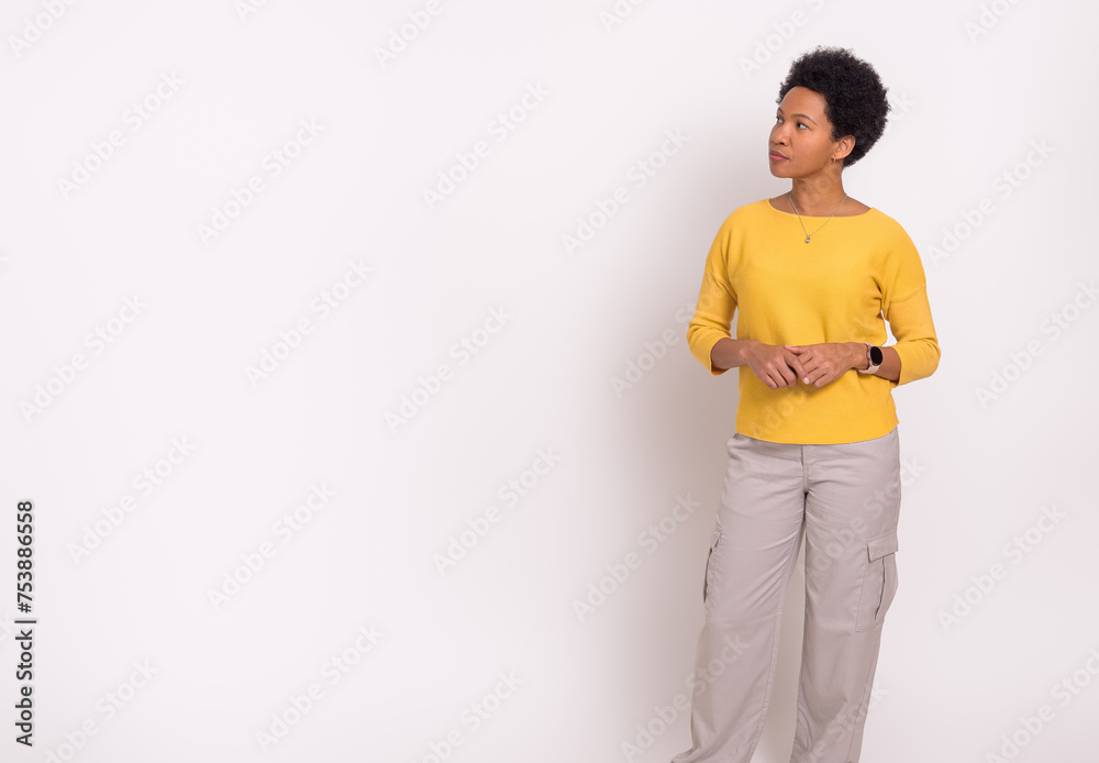 Young businesswoman with afro hairstyle looking away and thinking strategies over white background