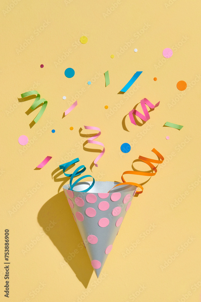 birthday hat with confetti on paper background birthday hat with confetti on paper background