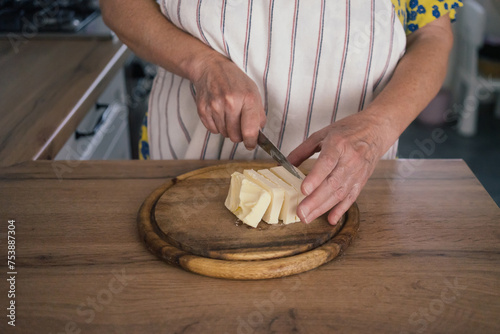 Close up woman cuts butter with knife