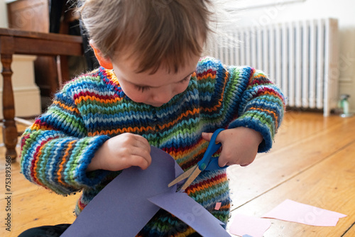 Toddler Learns to Cut Paper with Safety Scissors photo