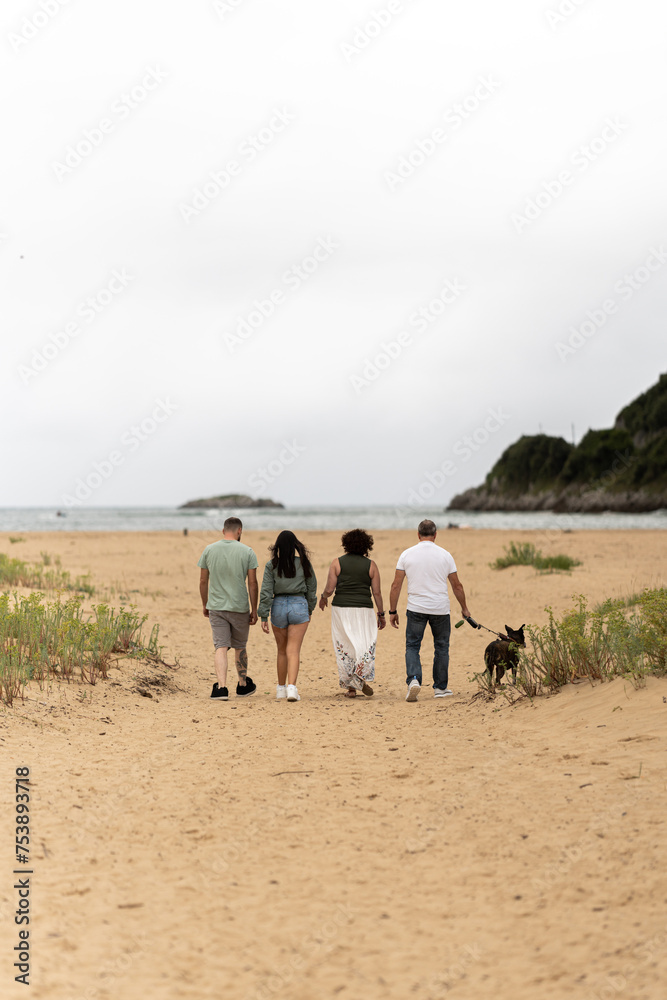 Family and dog walking outdoors. Family and dog walking outdoors.