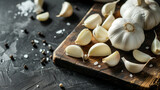 Close up of garlic bulbs with cloves on wooden board 