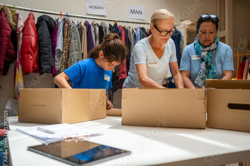 volunteers assembling cardboard gift boxes photo