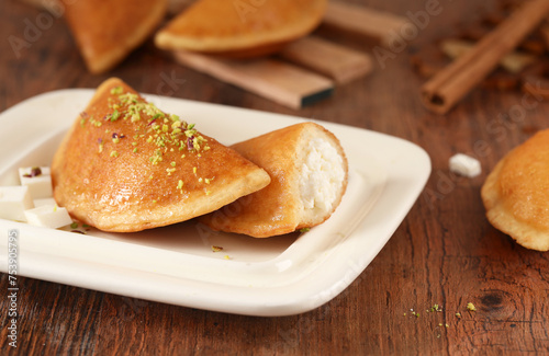qatayef Ramadan Traditional Sweets cheese on wood background