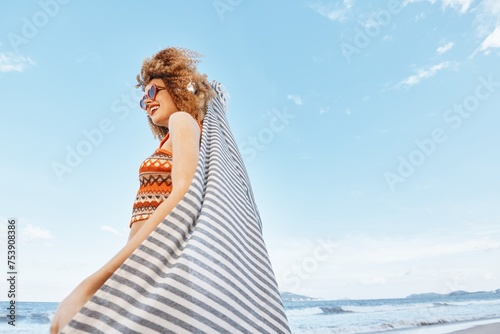 Carefree Summer Bliss  Smiling Woman Embracing the Freedom of Beach Vacation  Surrounded by Nature and Sunlight