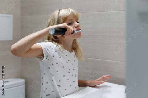 A little girl brushing teeth  photo