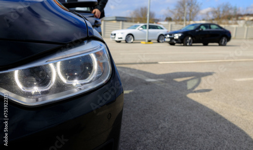 Photo of the front headlight of a premium car in a rental car that needs surface maintenance © losonsky