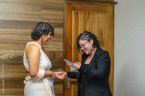 Woman reading vows to her lgbt partner at her wedding photo