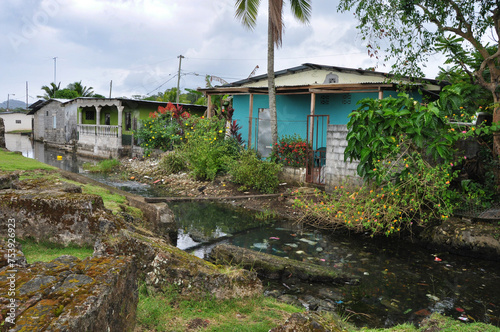 Maisons avec rivière polluée et pont de fortune, Colon, Panama, horizontal