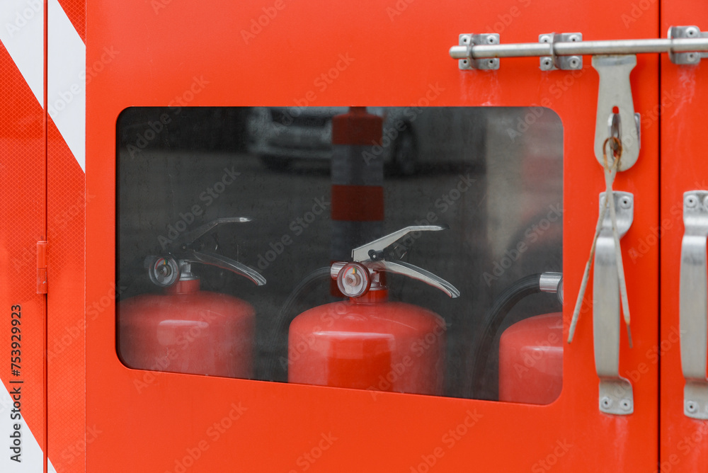 Fire extinguisher inside a red cabinet. Fire extinguisher inside a red cabinet.
