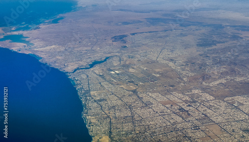 aerial landscape view of Jeddah a port city in Makkah Province, Saudi Arabia with coastline, city and King Abdulaziz International Airport photo