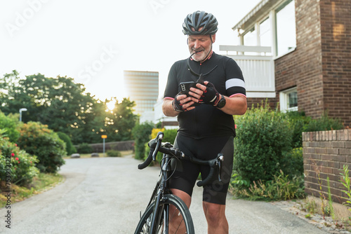 Cyclist with smartphone photo