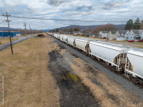Sayre, PA, USA - 03-03-2024 - Cloudy winter aerial image of a bulk materials railroad car near downtown area in the City of Sayre, PA. 