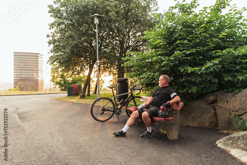 Cyclist man resting on bench