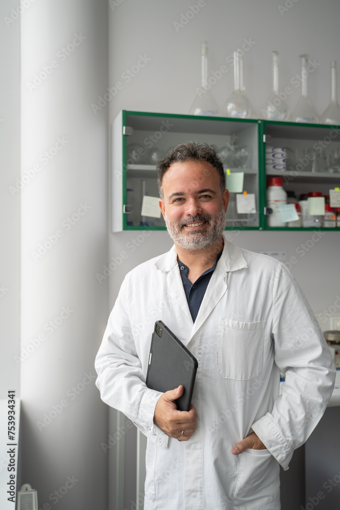 Middle Age Male Scientist Holding Tablet In Lab Middle Age Male Scientist Holding Tablet In Lab