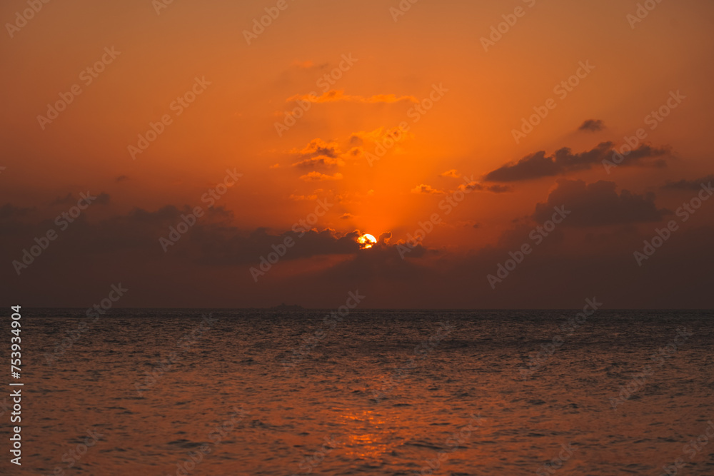 Magic orange sunset view.
A sunset is a natural phenomenon that occurs daily as the sun dips below the horizon, marking the end of daylight hours. It is a breathtaking and often picturesque event 