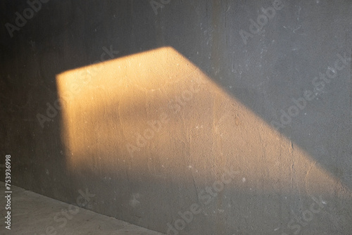 Golden hour reflection on a grey brutal concrete wall photo