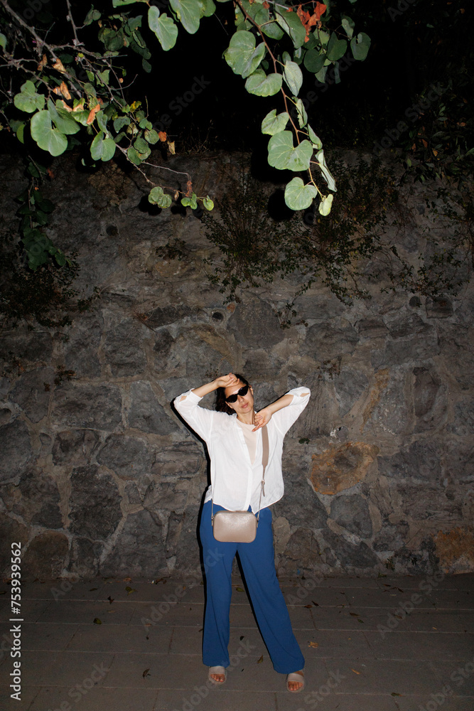 a woman against a stone wall a woman against a stone wall
